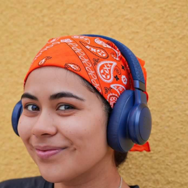 "a woman wearing headphones and an orange bandana"