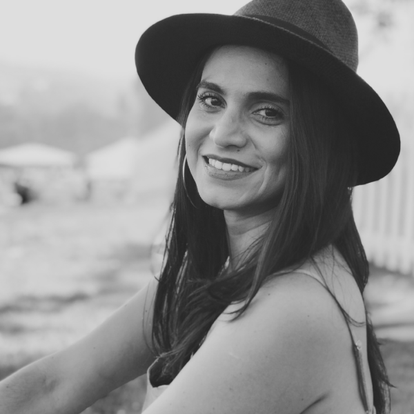 "black and white photo of a woman wearing a hat"